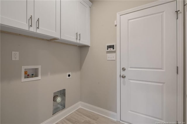 washroom featuring electric dryer hookup, cabinets, light wood-type flooring, and hookup for a washing machine