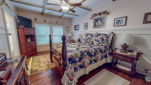 bedroom with coffered ceiling, ceiling fan, crown molding, and dark wood-type flooring