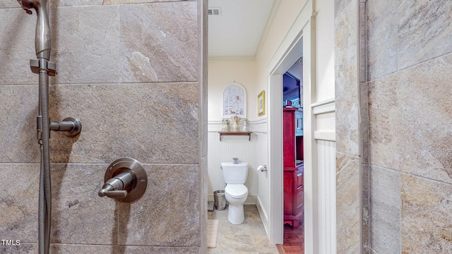 bathroom with tile patterned floors, toilet, and ornamental molding