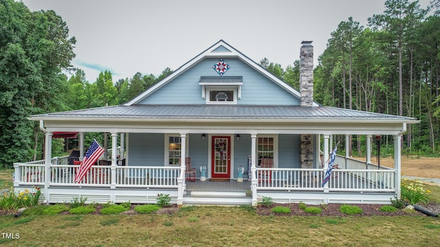 country-style home with covered porch and a front yard