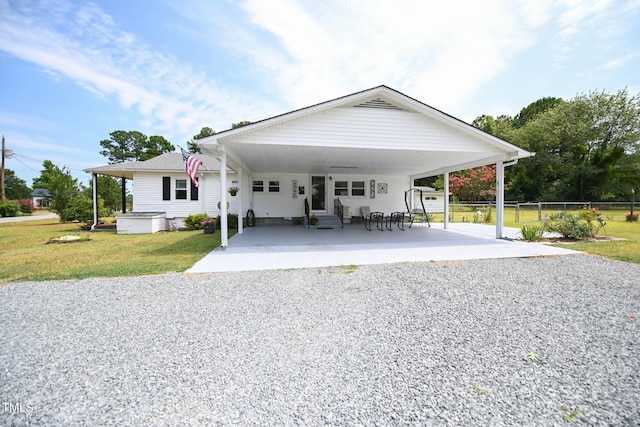 view of front of property featuring a carport and a front lawn