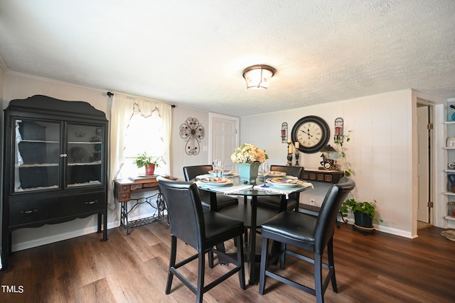 dining room featuring hardwood / wood-style flooring and a textured ceiling