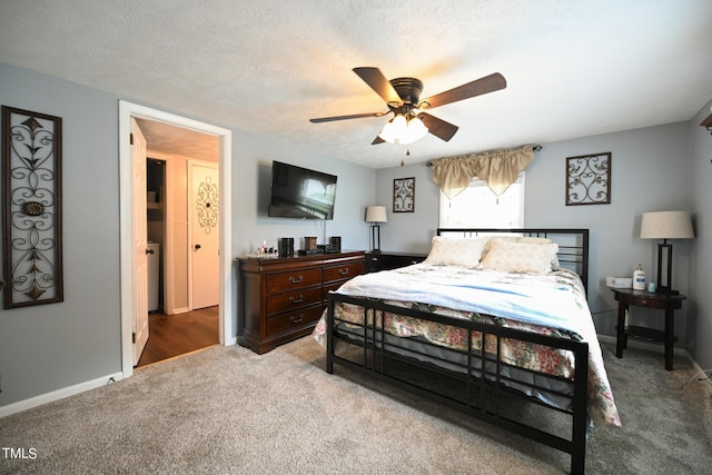 bedroom with ceiling fan, carpet flooring, and a textured ceiling