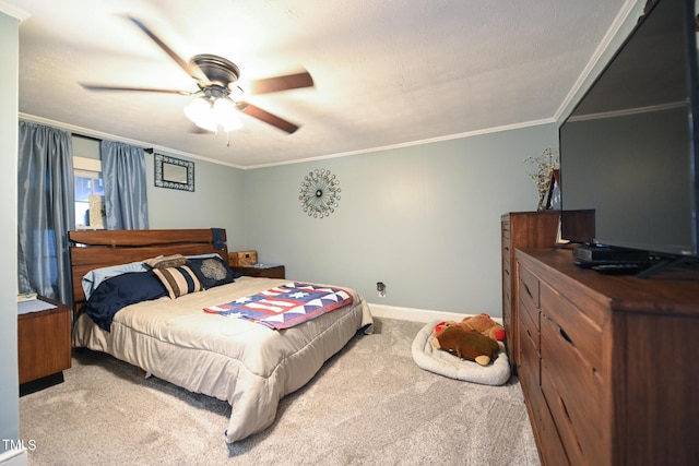 carpeted bedroom featuring ceiling fan and ornamental molding