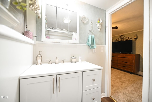 bathroom with ornamental molding and vanity