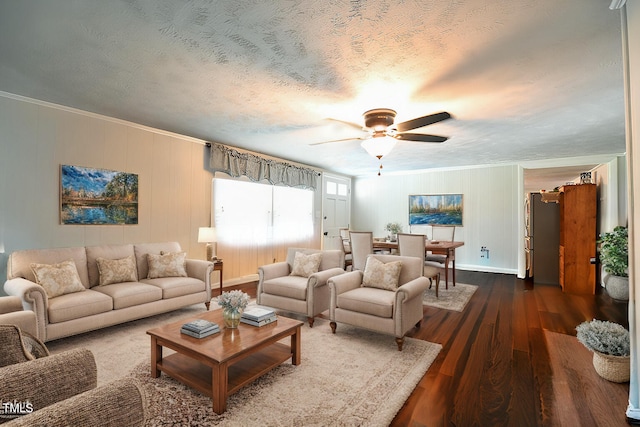 living room featuring crown molding, dark hardwood / wood-style floors, ceiling fan, and a textured ceiling