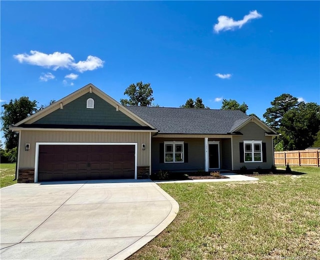 ranch-style house with a garage and a front lawn