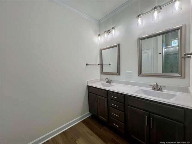 full bathroom featuring crown molding, double vanity, baseboards, and a sink