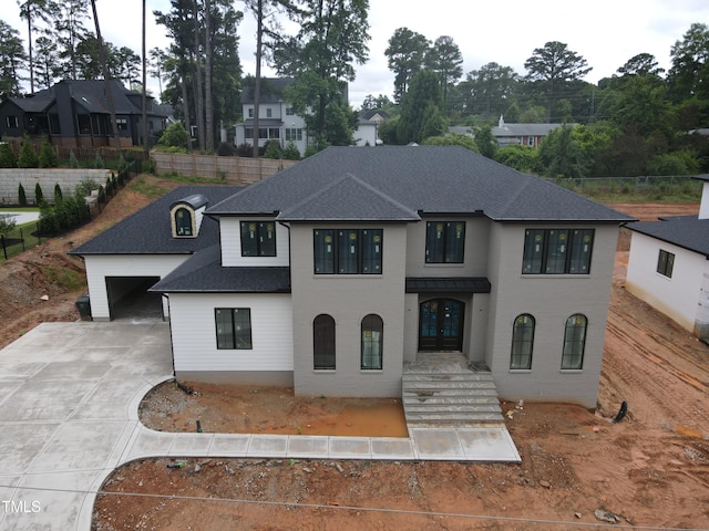 865 Wimbleton Dr, Raleigh, NC 27609 - french provincial home featuring roof with shingles, driveway, a garage, french doors, and a residential view