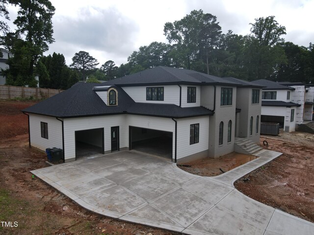 865 Wimbleton Dr, Raleigh, NC 27609 - view of front of property featuring concrete driveway, a garage, and roof with shingles