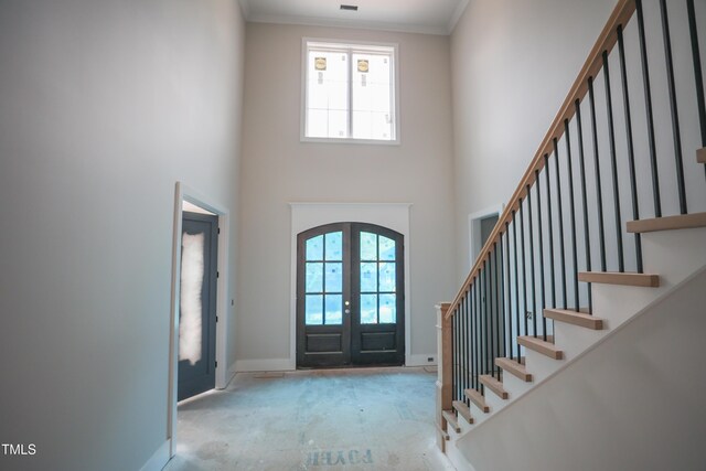 865 Wimbleton Dr, Raleigh, NC 27609 - entrance foyer with healthy amount of natural light, french doors, a high ceiling, stairs, and crown molding
