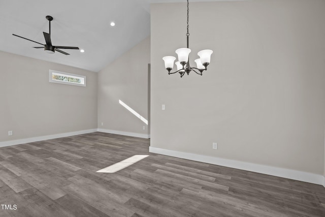 unfurnished dining area with hardwood / wood-style flooring, ceiling fan with notable chandelier, and high vaulted ceiling