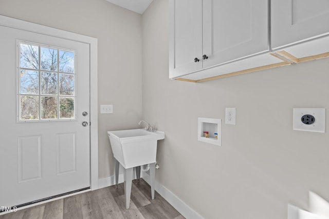 laundry area with cabinets, washer hookup, hookup for an electric dryer, and light hardwood / wood-style floors