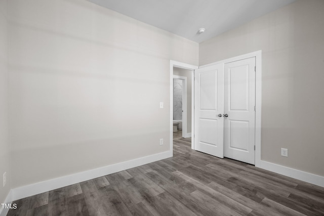 unfurnished bedroom with hardwood / wood-style flooring