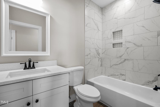 full bathroom featuring tiled shower / bath combo, vanity, and toilet