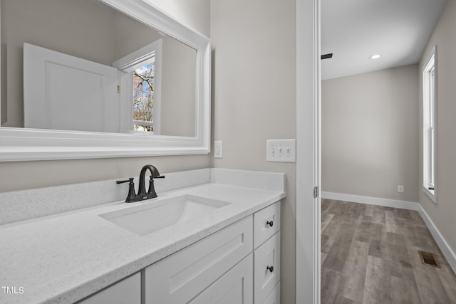 bathroom featuring hardwood / wood-style flooring and vanity