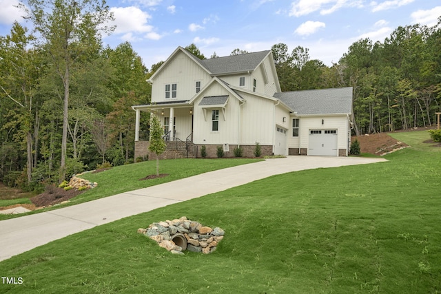 view of front of property featuring a front yard, a porch, and a garage