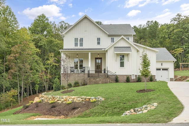 modern farmhouse style home with a garage, a front lawn, and covered porch