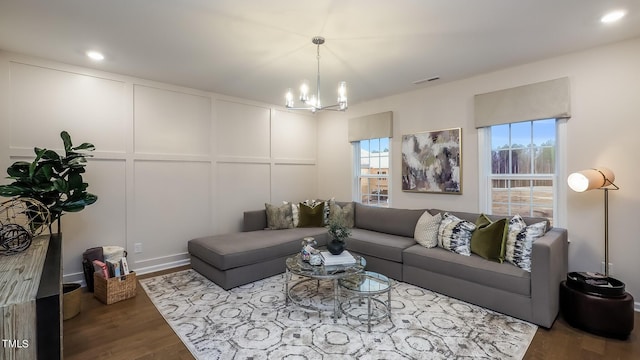 living room featuring hardwood / wood-style floors and a notable chandelier