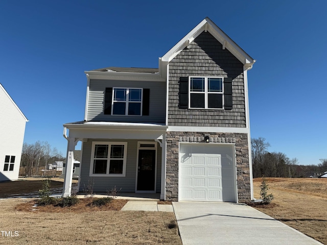 view of front of property with a garage, stone siding, and driveway