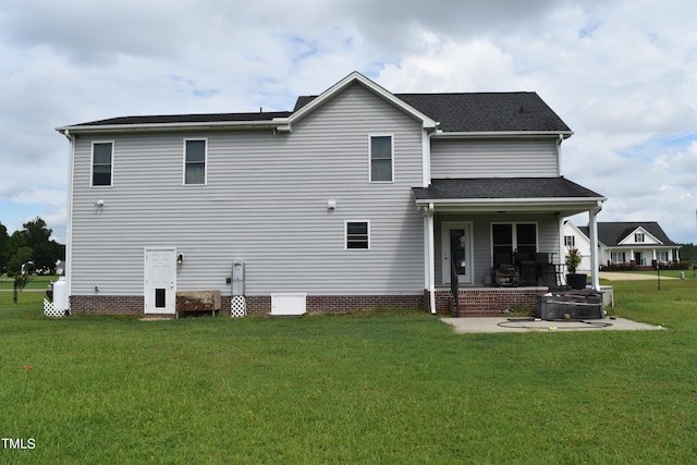 rear view of house featuring a yard and a patio