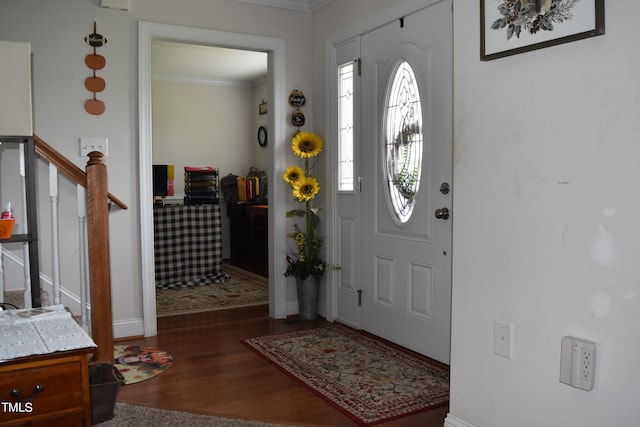 entrance foyer with dark hardwood / wood-style floors and crown molding