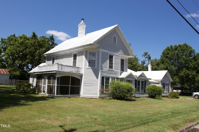 exterior space with a balcony and a front lawn