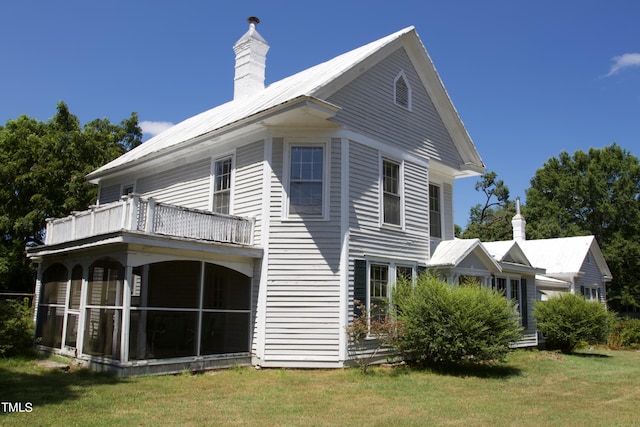 9358 Main St, Castalia, NC 27816 - rear view of house featuring a chimney, a balcony, a sunroom, and a lawn