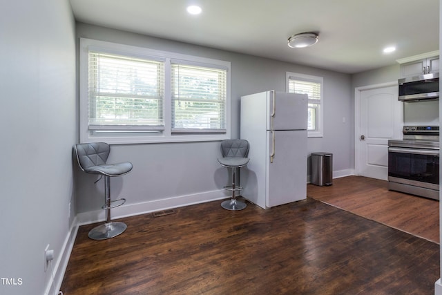 kitchen featuring hardwood / wood-style flooring, stainless steel appliances, and a healthy amount of sunlight