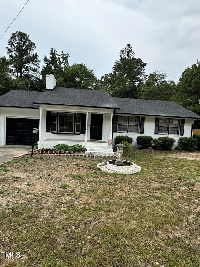 ranch-style home featuring a garage and a front yard