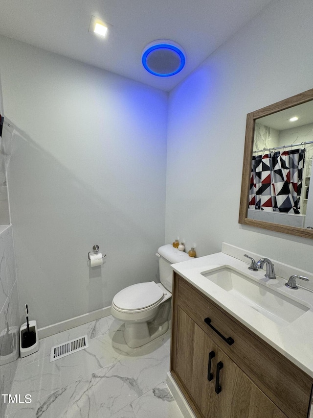 bathroom with tile patterned floors, toilet, and vanity