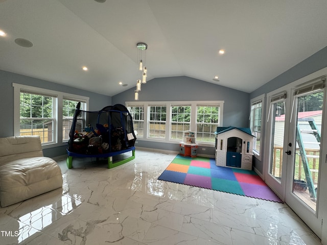 recreation room with tile patterned floors and vaulted ceiling