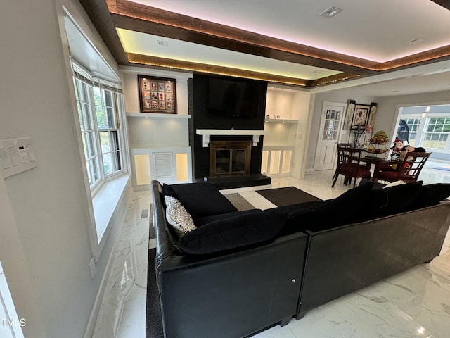 living room featuring a healthy amount of sunlight, tile patterned floors, and built in shelves