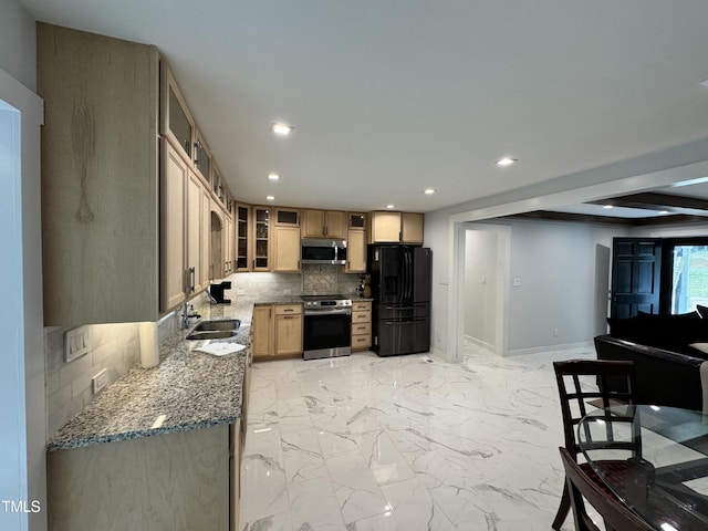 kitchen with beam ceiling, tasteful backsplash, appliances with stainless steel finishes, stone countertops, and sink