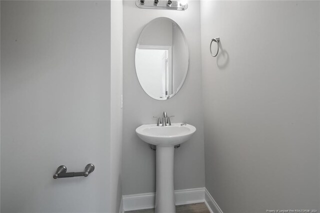 57 E Third St, Parkton, NC 28371 - bathroom featuring a sink and baseboards