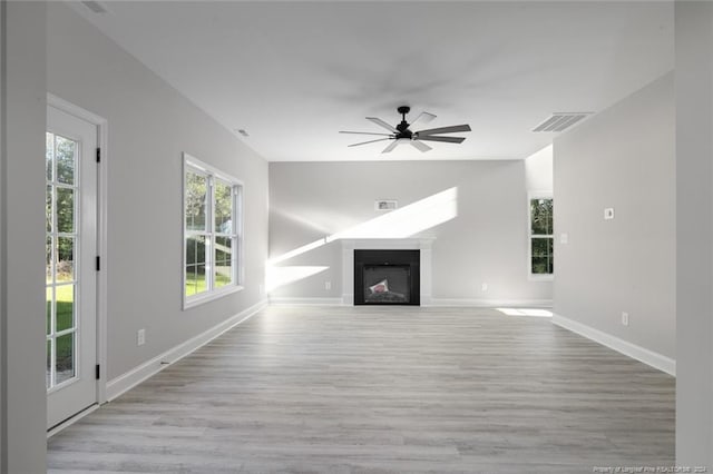 unfurnished living room with light wood-type flooring and ceiling fan