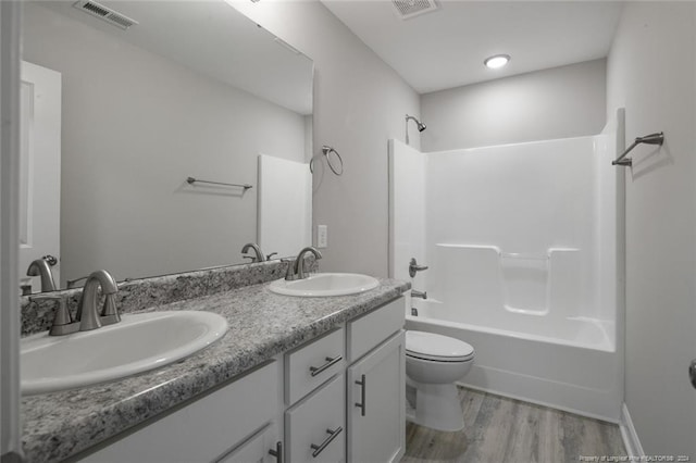 full bathroom featuring wood-type flooring, vanity, toilet, and shower / tub combination