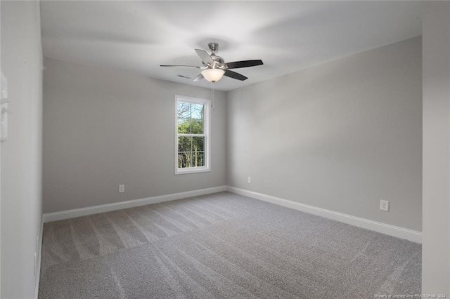 carpeted spare room with ceiling fan
