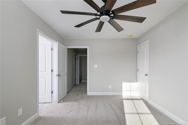 unfurnished bedroom featuring light carpet and ceiling fan