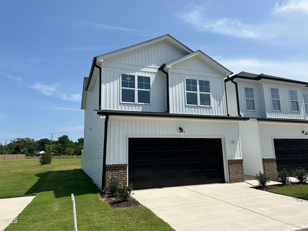 view of front facade with a front lawn and a garage