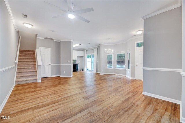 unfurnished living room featuring light hardwood / wood-style flooring, ceiling fan with notable chandelier, and crown molding