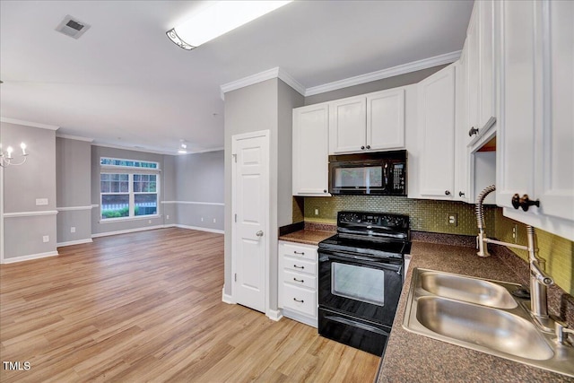 kitchen featuring light hardwood / wood-style floors, white cabinetry, sink, black appliances, and decorative backsplash