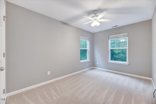 unfurnished room with ceiling fan and carpet floors