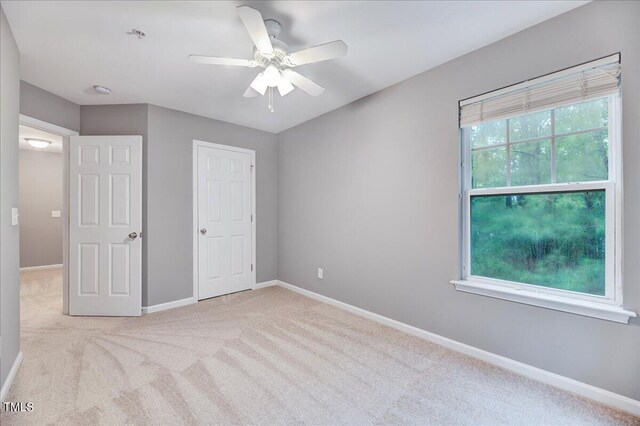 unfurnished bedroom featuring light carpet and ceiling fan