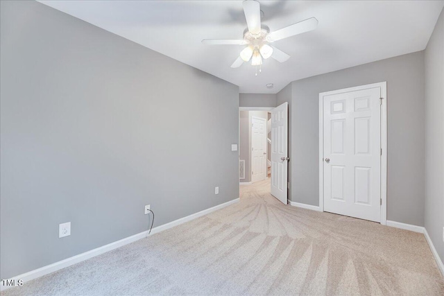 unfurnished bedroom with ceiling fan and light carpet