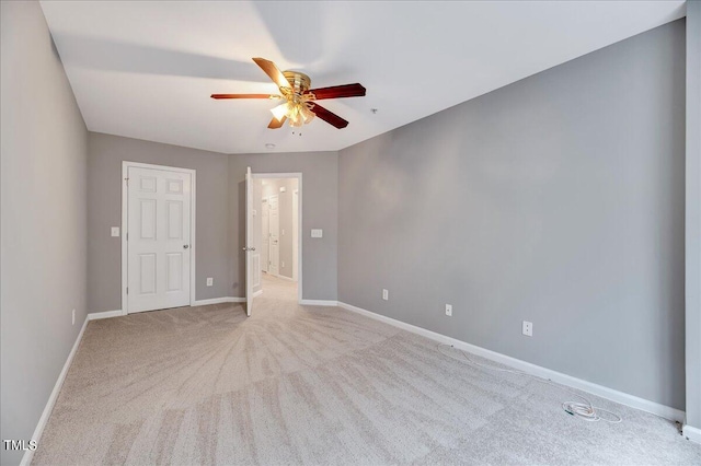 spare room featuring ceiling fan and carpet floors