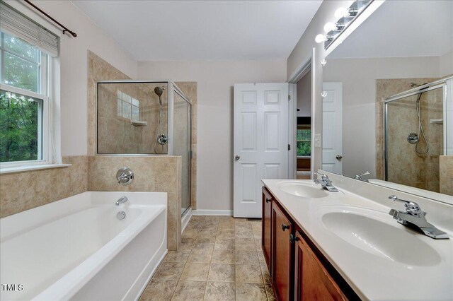 bathroom with dual vanity, tile patterned flooring, and independent shower and bath