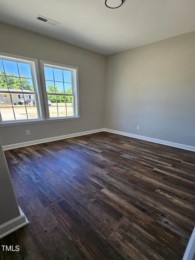 unfurnished room with dark hardwood / wood-style floors