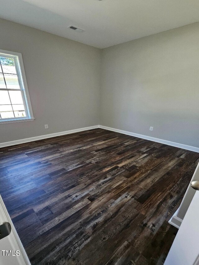 empty room featuring dark hardwood / wood-style flooring