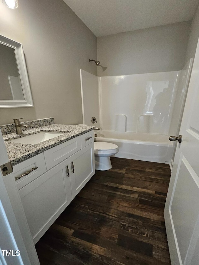 full bathroom featuring vanity, shower / bathing tub combination, wood-type flooring, and toilet